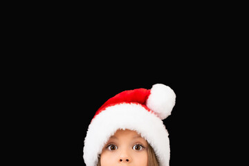 Beautiful little girl in a Christmas hat.