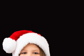 A child in a Christmas hat looks out.