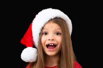 The little girl in the Christmas hat is very surprised.
