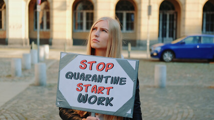 Young woman calling to stop quarantine and start working. She walking down the street.