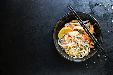 rice noodles Funchoza seafood cellophane pasta shrimp, mussels, squid preparing healthy meal snack top view copy space for text food background rustic