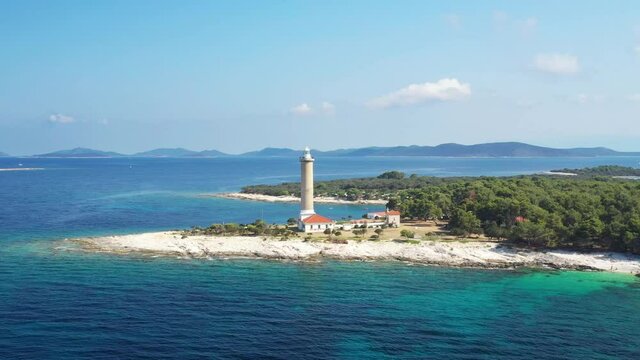 Aerial view of lighthouse tower of Veli Rat on the island of Dugi Otok, Croatia in early morning, Adriatic sea in background
