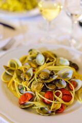 Frech homemade spaghetti pasta with vongole sea sheels and small red tomatoes