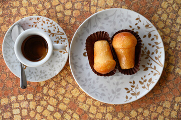 Classic italian espresso coffee served with homemade rum baba soft cake
