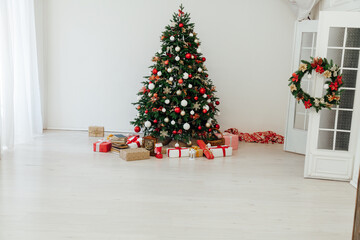 Christmas tree with gifts in the interer lights garland decor new year