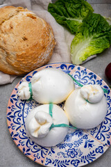 Cheese collection, fresh soft Italian cheese from Puglia, white balls of burrata or burratina cheese made from mozzarella and cream filling