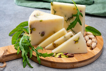 Cheese collection, fresh Italian pecorino cheese made from sheep milk filled with pistachio nuts...