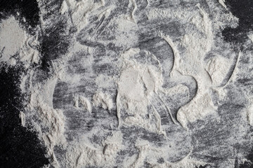 White flour on black background texture photo