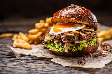 Burger stuffed with shredded confit turkey egg mushrooms and french fries