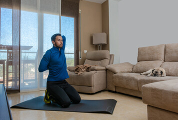 Latin man, doing a workout in his living room.