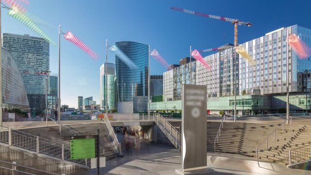 Panorama of La Defence timelapse hyperlapse, business and financial district with highrise skyscrapers buildings and cranes with exit from metro station