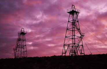 Abandoned oil rig with dramatic sky clouds
