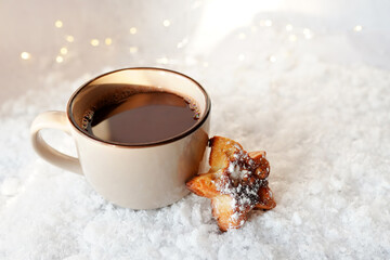 christmas cookie an cup of coffee staying on snow, concept of winter morning