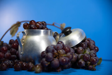 Fresh fruits and grape berries on blue background.