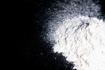 On the right side of the screen is a handful of white flour on a dark background. The left part is free.