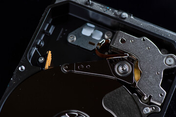 Disassembled dusty hard drive close-up.