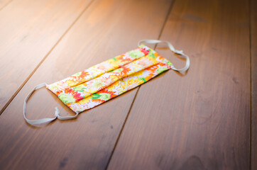 The photo shows facemask on the table as a protection aqainst Covid-19