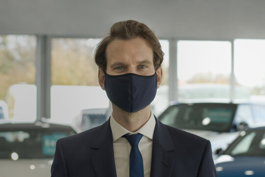 Portrait of car salesman wearing protective face mask