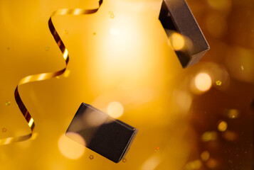 Creative photo of levitating gift box on golden background. Copy space. Celebration atmosphere. Christmas present promo