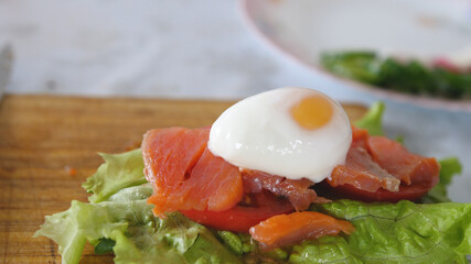 Toast with poached egg, herbs, salmon and tomato. breakfast, lunch, dinner