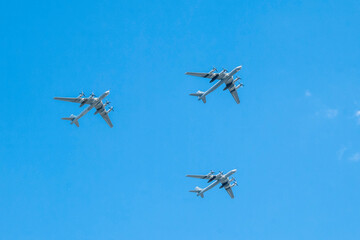 Three turboprop military aircraft in the sky