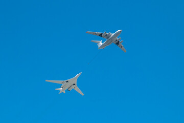 Two military aircraft refuel in the sky
