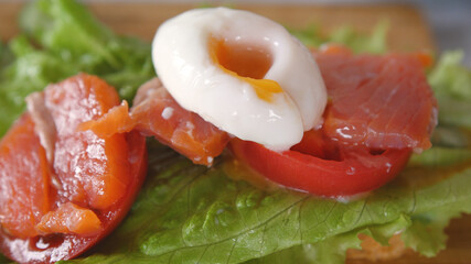 Toast with poached egg, herbs, salmon and tomato. breakfast, lunch, dinner