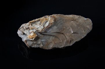 bifacial backed knife. Knife carved in flint from the Middle Paleolithic, on black background