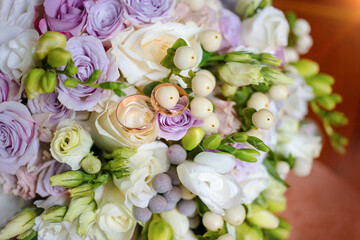 Delicate white roses, wedding bouquet of purple flowers. wedding bouquet of roses and rings