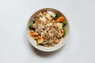 A mixed vegetable salad.Bowl of healthy vegetable salad isolated on white background, top view. Healthy food, vegetarian dieting.Salad with spinach.