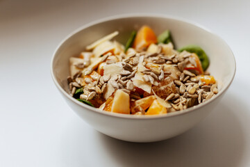A mixed vegetable salad.Bowl of healthy vegetable salad isolated on white background, top view. Healthy food, vegetarian dieting.Salad with spinach.