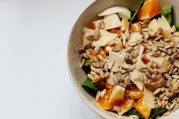 A mixed vegetable salad.Bowl of healthy vegetable salad isolated on white background, top view. Healthy food, vegetarian dieting.Salad with spinach.