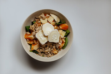A mixed vegetable salad.Bowl of healthy vegetable salad isolated on white background, top view. Healthy food, vegetarian dieting.Salad with spinach.