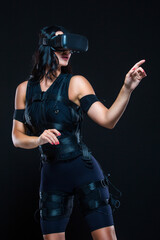 A young woman in a virtual reality suit that allows her whole body to plunge into VR. EMS.