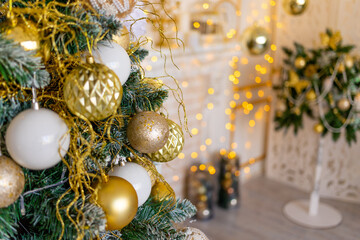 new year's interior of the house in gold color, Christmas tree with balloons and garland
