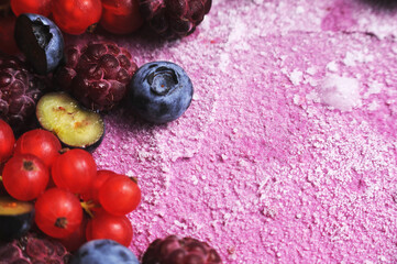 Festive cake, blueberry and blackberry sponge cake with cream cheese inside on a plate on a wooden table, horizontal view from above.Macro photo.