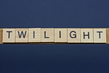 gray word twilight from small wooden letters on a black table