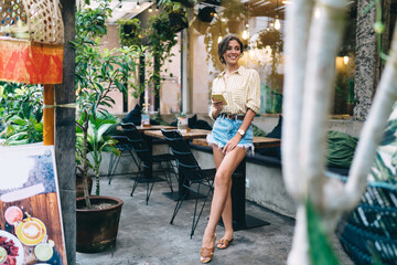 Joyful woman using smartphone on terrace