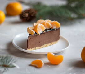 cake background. Close up background of chocolate cake. Fresh chocolate cake background. Homemade chocolate cake background. Tangerines and spruce branches. copyspace