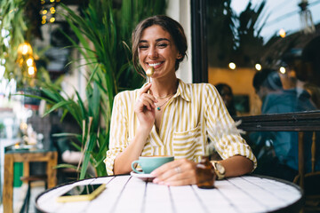 Cheerful woman with coffee and teaspoon