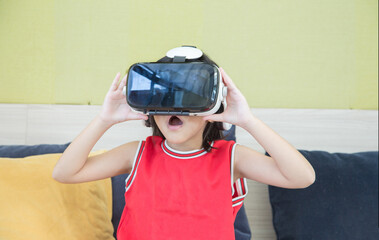 asian kid play vr glass technology on living room