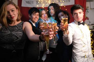 Friends at a Christmas party making a toast in a bar. Christmas celebration.