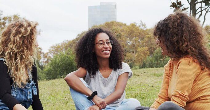 Multiracial women talking in park