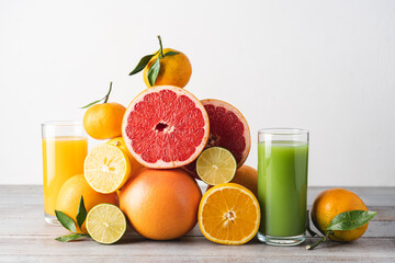 Naklejka na ściany i meble Creative composition of slices citrus fruit and glasses of juice. Seasonal fruits are source of vitamin C and strengthen immunity