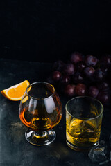 Whiskey and cognac in glasses on a dark background. copyspace