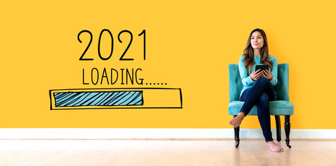 Loading new year 2021 with young woman holding a tablet computer