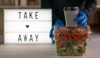 Front view of food on plastic containers ready to take away. Food delivery concept