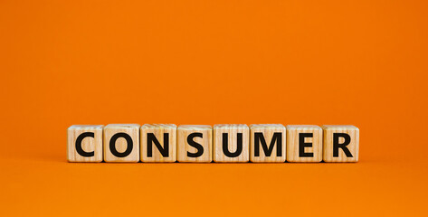 Concept word 'consumer' on cubes on a beautiful orange background. Business concept. Copy space.