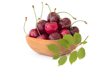 Ripe cherries in the wood bowl with sprig isolated on white