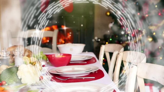 Animation of table set for christmas meal with white spinning circles